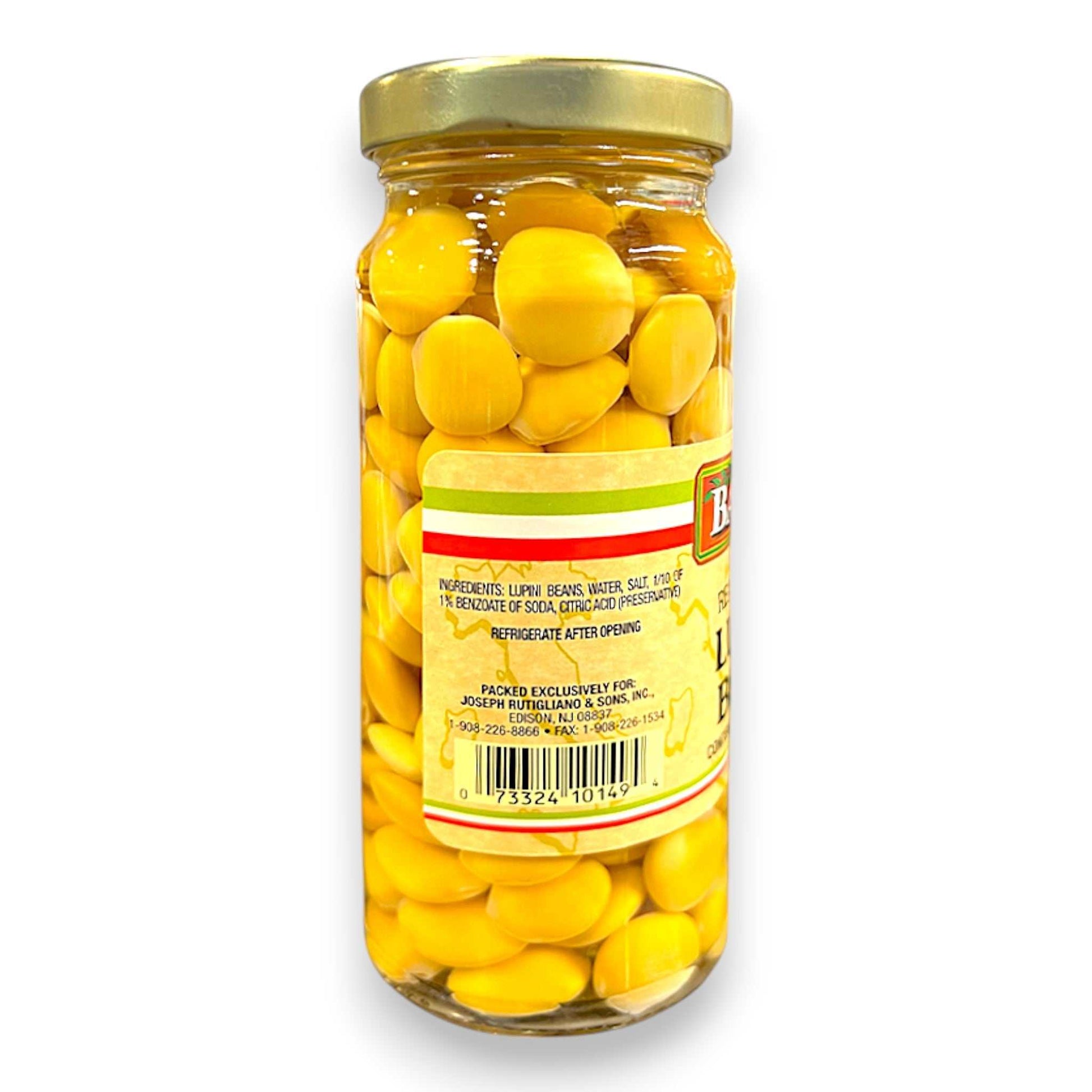 Jar of yellow lentils with a gold lid on a white background