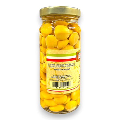 Jar of yellow lentils with a gold lid on a white background